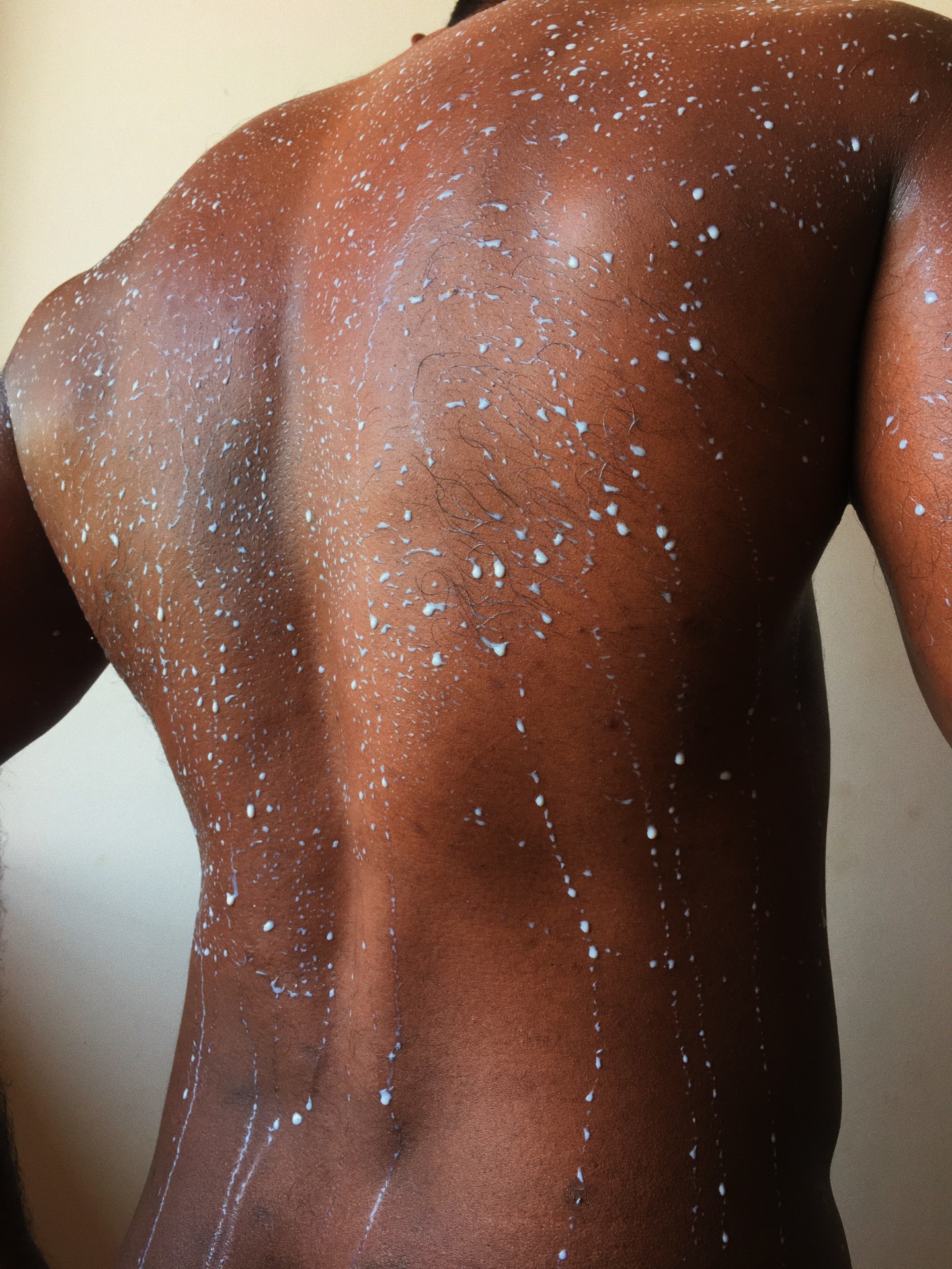 Male model will milk dripping over his back.