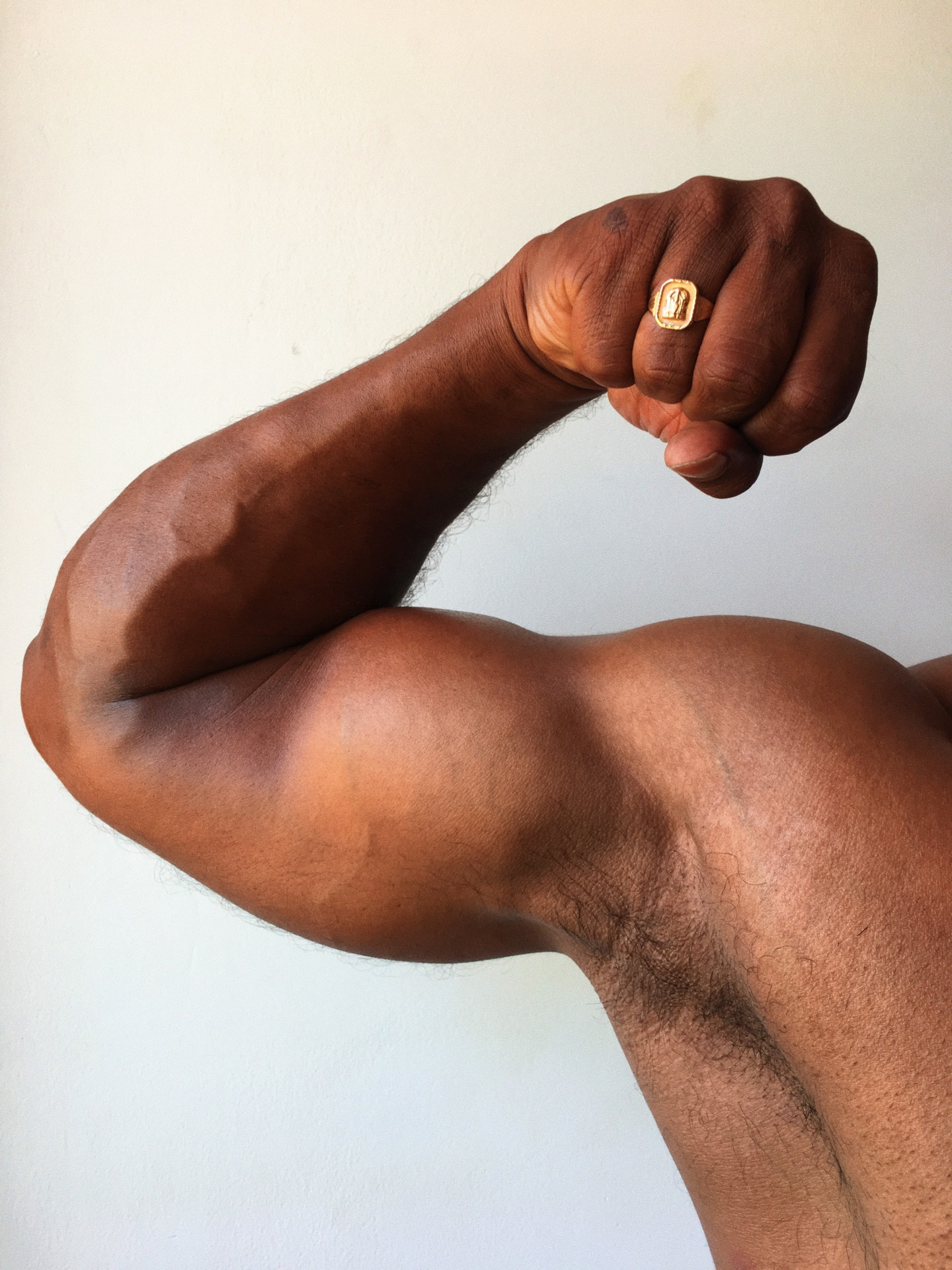 Desi hunk flexing biceps.
